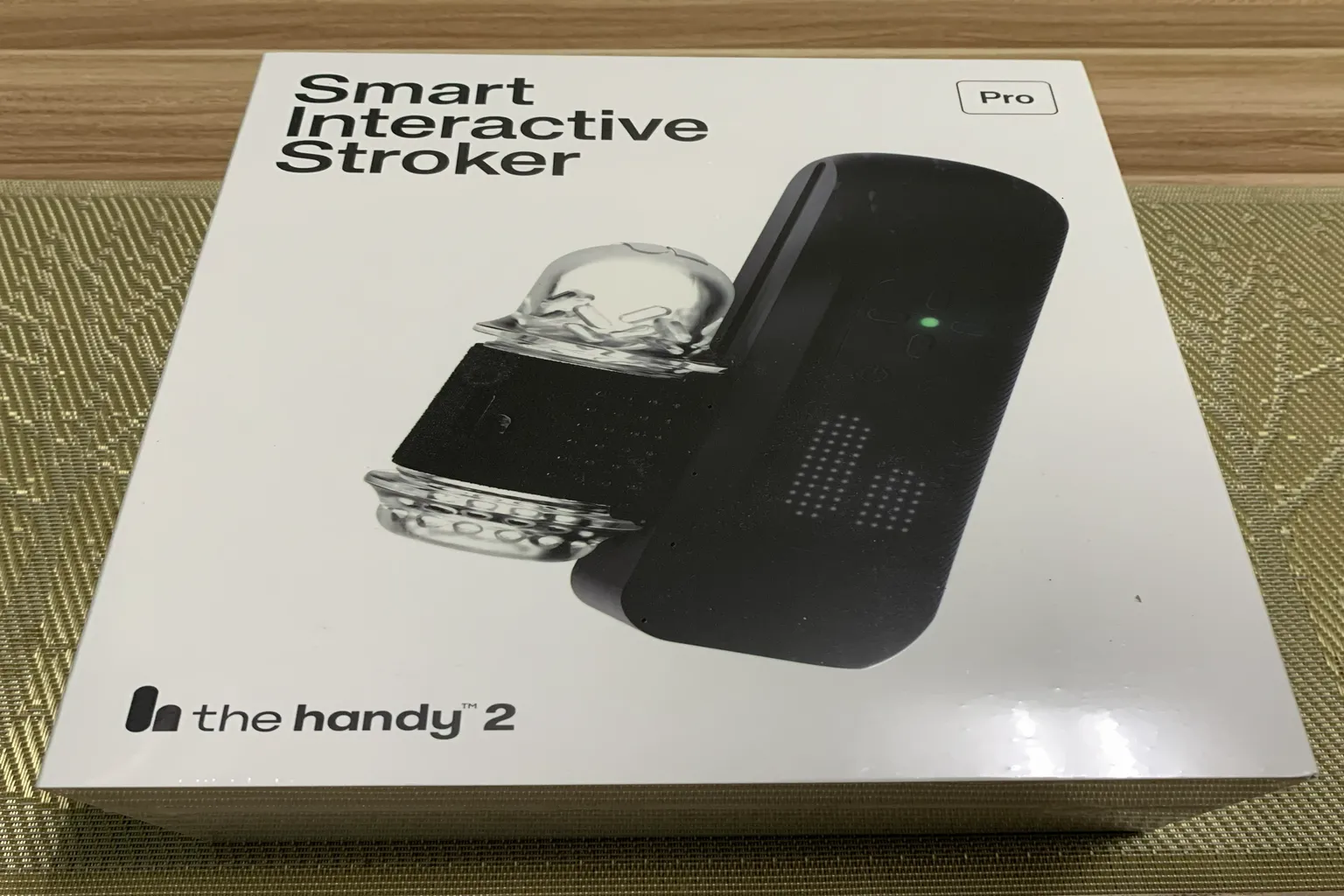 The Handy 2 Pro Smart Interactive Stroker retail box placed on a table, showing the product image and packaging design.