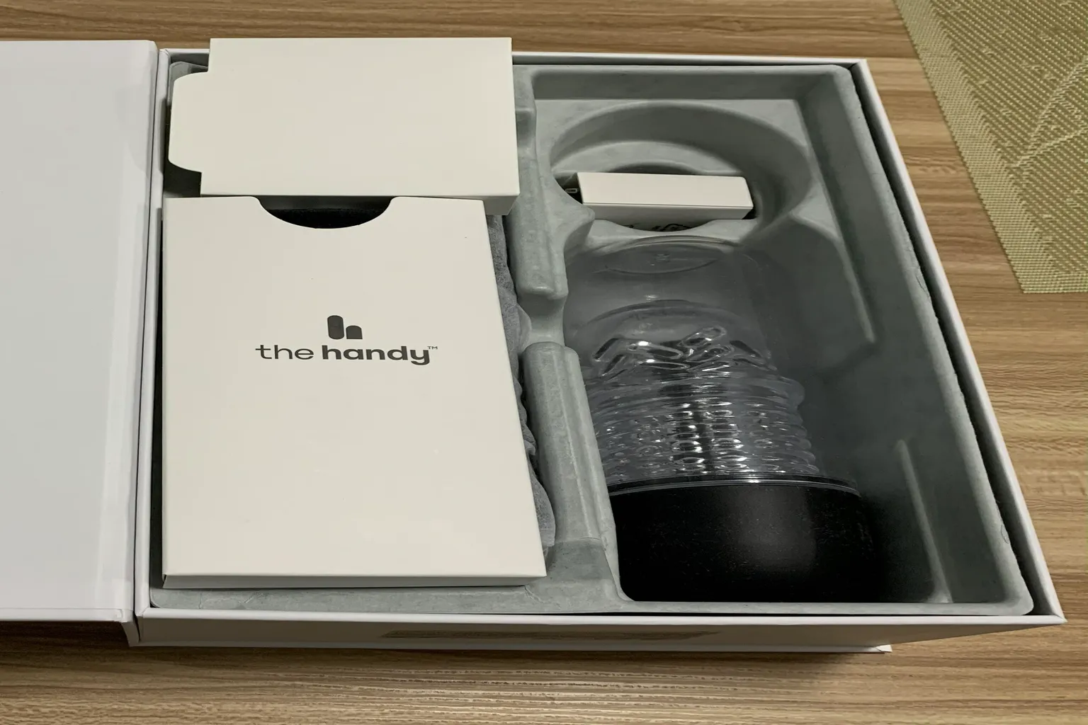 Opened The Handy 2 Pro box showing the main device, sleeve, and accessory boxes arranged inside the molded tray.