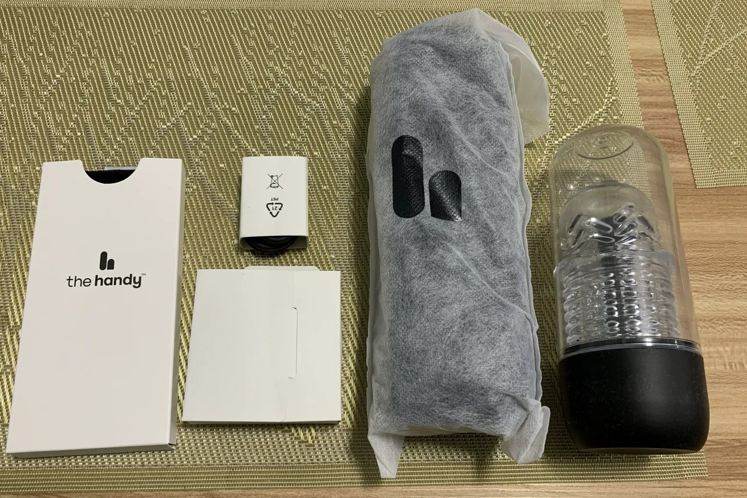 The Handy 2 Pro package contents partially removed from the box, including the wrapped main device, sleeve, and accessory boxes.